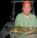 Dr. Dennis Stokes from the Memphis Fly Fishing Club with a beautiful red caught on a glass minnow pattern.  Check out all those spots and the blue tail!